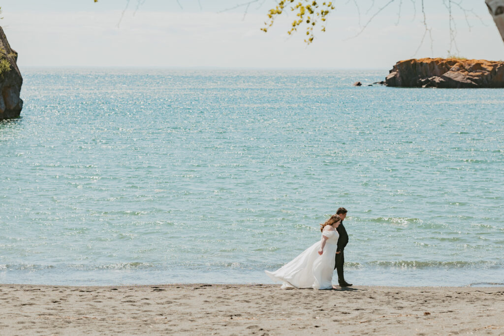 couples walk on the sandy beach