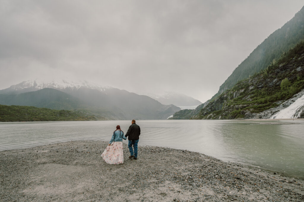 Couple walk with the Mendenhall Glacier view