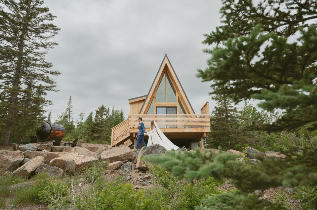 couple walk past the aframe cabin