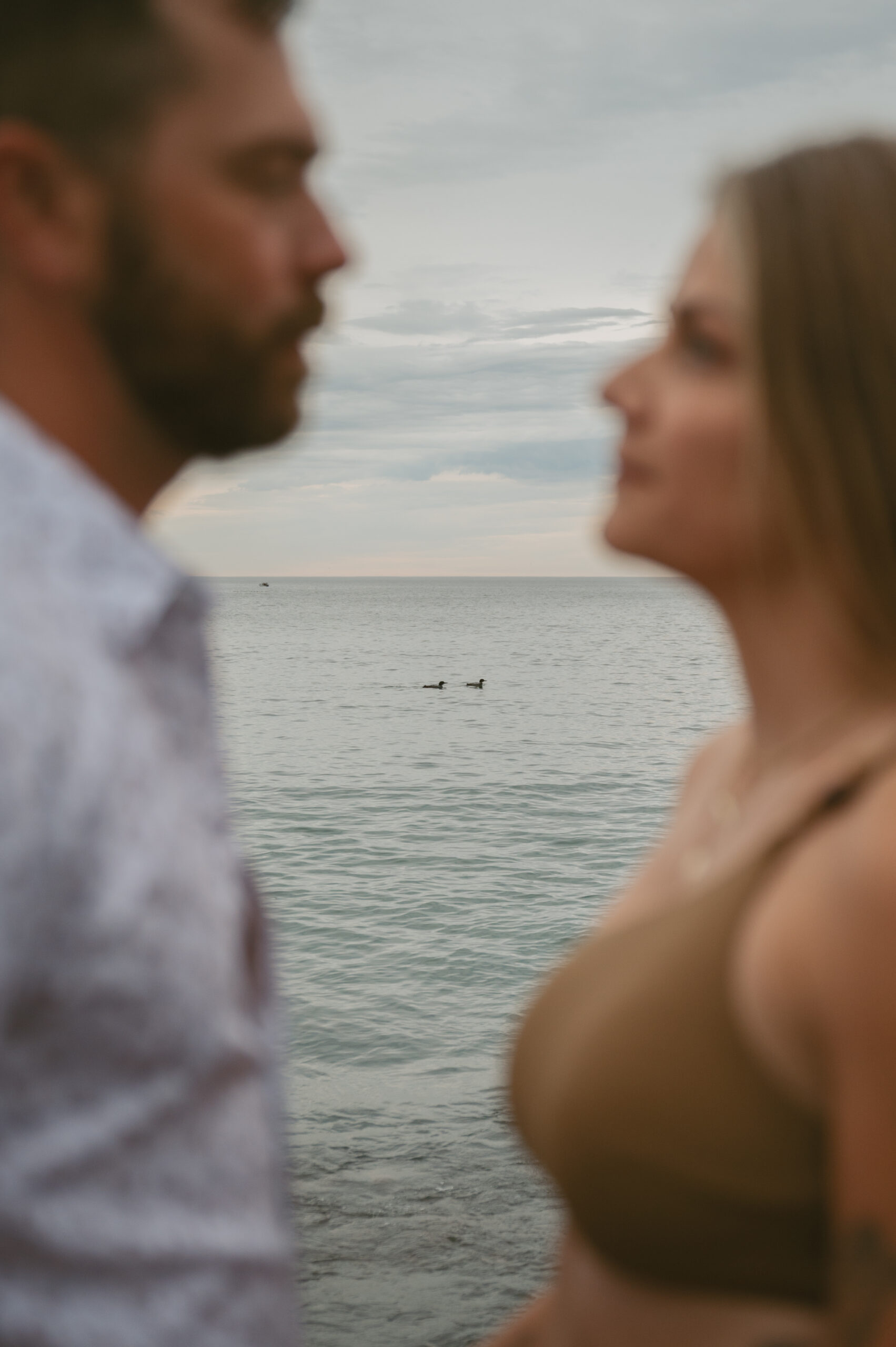 A gif of couple spinning in a circle on the beach