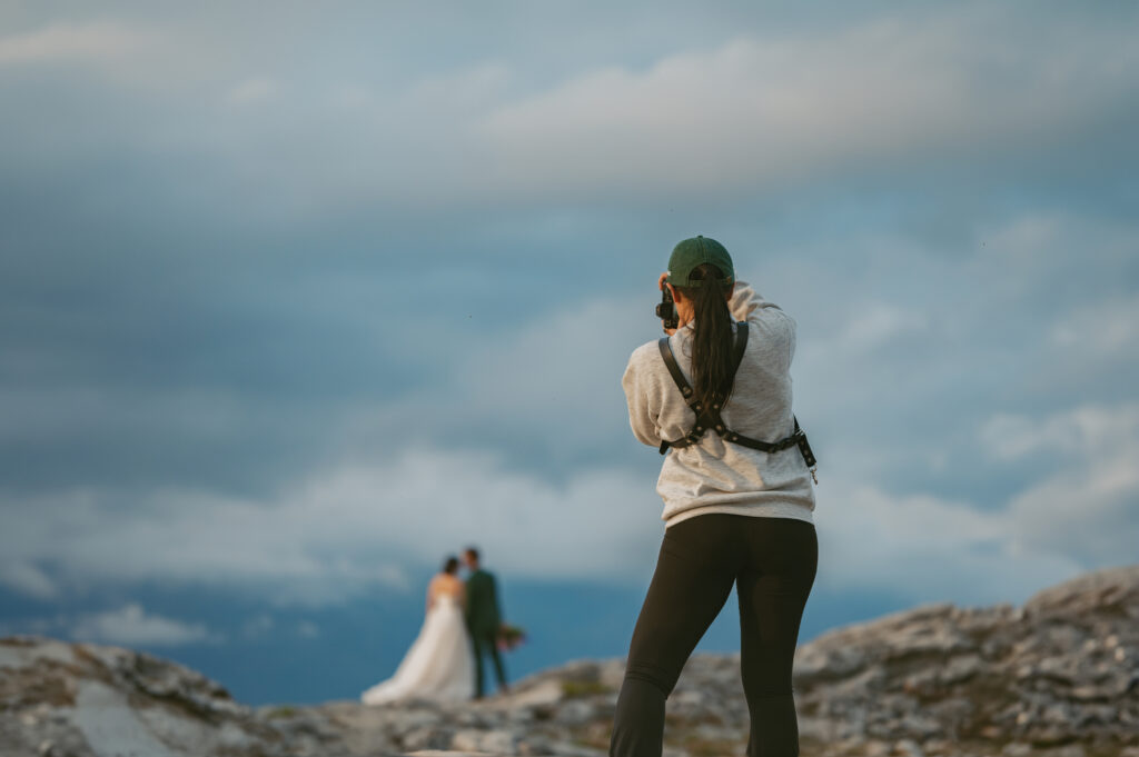 Photographer taking picture of couples on the mountains