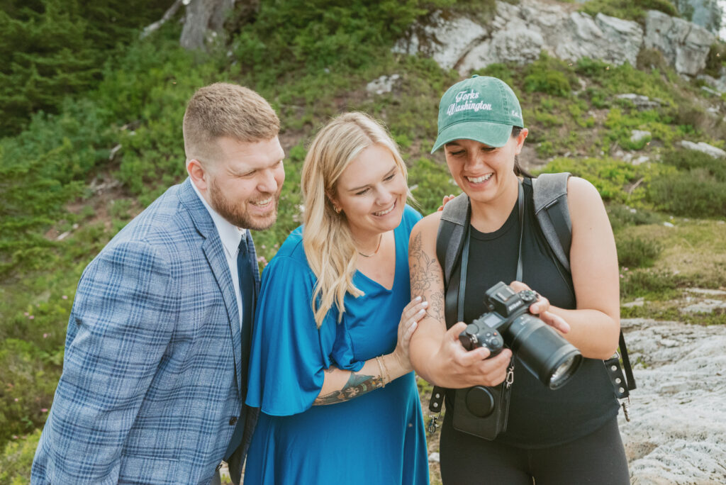 photographer show the couples the photos on the camera