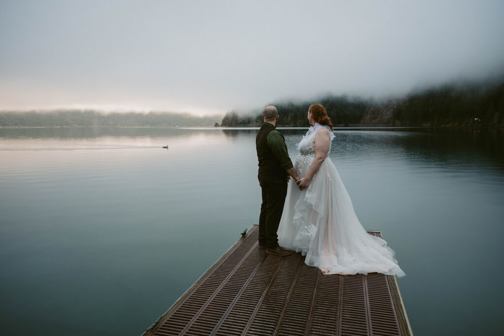 Moody morning on Lake Crescent with the geese swim across the lake and the elopement couple watching it