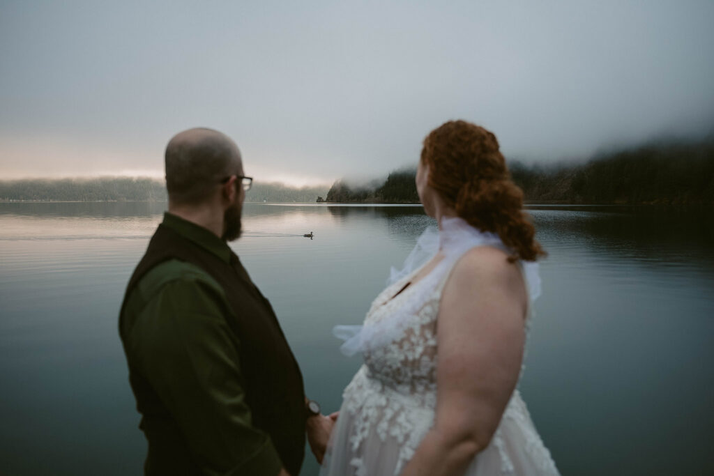 Olympic National park Elopement couple watch geese swim across the Lake crescent