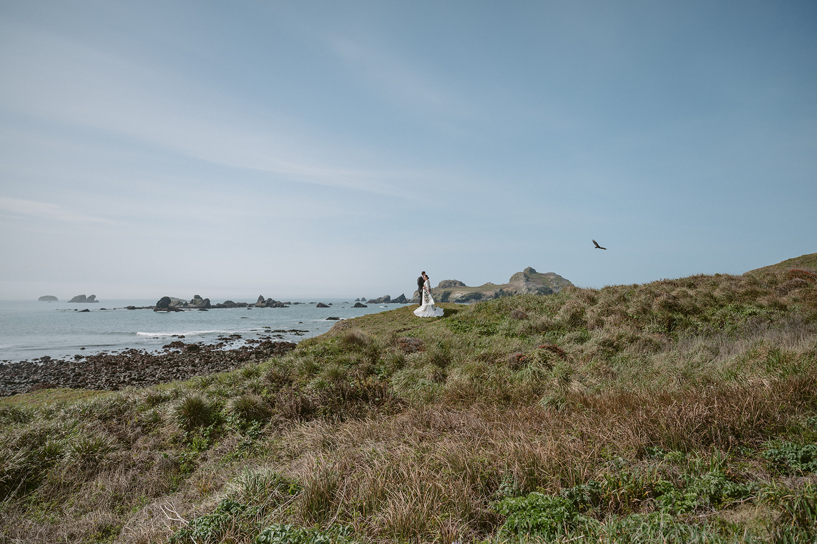 couple stand by the coast